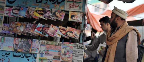 Pakistan men check for the headlines of newspapers on a stall in Rawalpindi on March 4, 2012. The International Monetary Fund (IMF) said Pakistan&#8217;s economy would speed up to a 3.4 percent growth pace in fiscal 2011-2012, which runs to June 30, compared to 2.4 percent last year. AFP PHOTO / Bay ISMOYO (Photo credit should read BAY ISMOYO/AFP/Getty Images)
