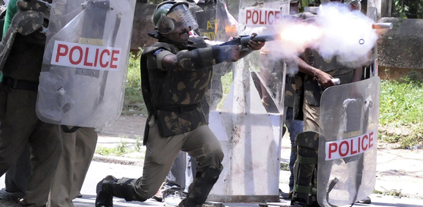 Indian police fire tear gas at members of the Telangana Students Joint Action Committe (TSJAC) as they prevent the students from marching during a protest rally held to demand the separate state of Telangana at the Osmania University in Hyderabad on September 30, 2012. Failing to get any assurance from Congress led UPA governement over statehood for Telangana in the southern Indian state of Andhra Pradesh, the Telangana Joint Action Committee (T-JAC) called all sections of society to participate in the Telangana march. AFP PHOTO / Noah SEELAM (Photo credit should read NOAH SEELAM/AFP/GettyImages)
