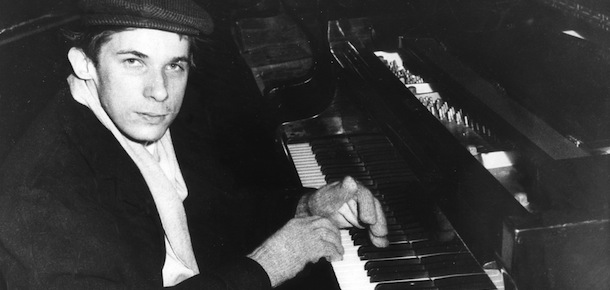 This is the costume that Canadian Pianist Glenn Gould met the press in May 19 in London. Heavy black overcoat, cloth cap. muffler and gloves. Gould says he doesn&#8217;t like &#8220;Pushed Air&#8221; -I.E.Air conditioning. He is rehearsing for series of Five Beethoven Concerts with London Symphony. For years he has been lowering the Piano Stoll an inch a Year and now it&#8217;s as low as it goes 14 inches from floor and he has put piano on two inch blocks. He said he wouldn&#8217;t sit on floor though and have people &#8220;Think I&#8217;m eccentric. (AP-Photo) 19.5.1959
