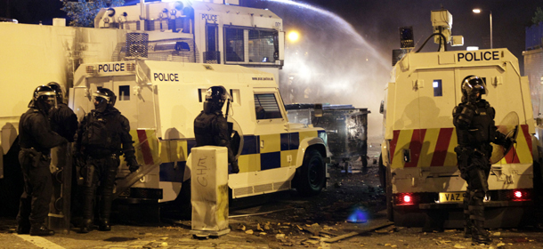 Police use a water cannon on loyalist rioters in North Belfast, Northern Ireland, Sunday, Sept. 2, 2012. A number of police were injured during a night of clashes. The violence came after unrest at marches in the area the previous weekend. (AP Photo/Peter Morrison)