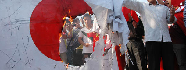 Chinese demonstrators set fire to a Japanese national flag during a protest over the Diaoyu islands issue, known as the Senkaku islands in Japan, in Wuhan, central China&#8217;s Hubei province on September 16, 2012. Thousands of anti-Japanese demonstrators mounted protests in cities across China on September 16 over disputed islands in the East China Sea, a day after an attempt to storm Tokyo&#8217;s embassy in the capital. CHINA OUT AFP PHOTO (Photo credit should read AFP/AFP/GettyImages)
