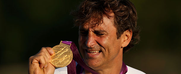 LONGFIELD, ENGLAND - SEPTEMBER 05: Alessandro Zanardi of Italy reacts on the podium after winning the Men's Individual H4 Time Trialon day 7 of the London 2012 Paralympic Games at Brands Hatch on September 5, 2012 in Longfield, England. (Photo by Clive Rose/Getty Images)