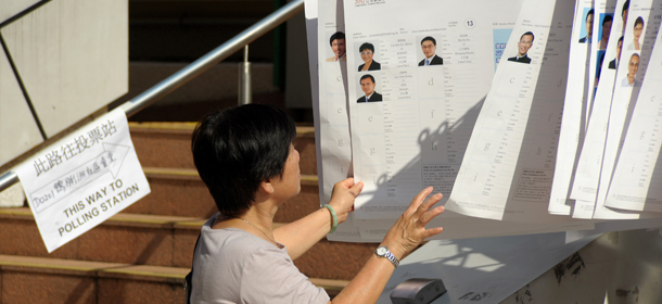 A woman looks at a display of various candidates running in the territory's legislative elections, outside a polling station in Hong Kong on September 9, 2012. Hong Kong voters went to the polls in legislative elections seen as a crucial test for the Beijing-backed government, as calls for full democracy grow and disenchantment with Chinese rule surges. AFP PHOTO / RICHARD A. BROOKS (Photo credit should read RICHARD A. BROOKS/AFP/GettyImages)