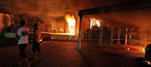 A vehicle (R) and the surround buildings burn after they were set on fire inside the US consulate compound in Benghazi late on September 11, 2012. An armed mob protesting over a film they said offended Islam, attacked the US consulate in Benghazi and set fire to the building, killing one American, witnesses and officials said. AFP PHOTO (Photo credit should read STR/AFP/GettyImages)