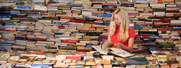 LONDON, ENGLAND &#8211; JULY 31: Employee Tilly Shiner looks at a book in the aMAZEme labyrinth at The Southbank Centre on July 31, 2012 in London, England. Brazilian artists Marcos Saboya and Gualter Pupo used 250,000 books to create the maze which will be on display until August 25, 2012. (Photo by Peter Macdiarmid/Getty Images)
