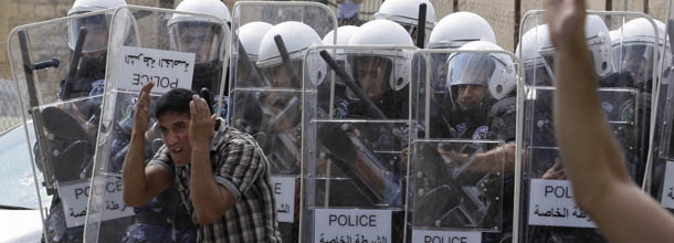 Palestinian police use shields to protect themselves from stones thrown by Palestinian demonstrators during a protest near the municipality building in the West Bank city of Hebron, Monday, Sept. 10, 2012. Palestinian demonstrators fed up with high prices and unpaid salaries shuttered shops, halted traffic with burning tires and closed schools throughout the West Bank on Monday in the largest show of popular discontent with the governing Palestinian Authority in its 18-year history. (AP Photo/Nasser Shiyoukhi)