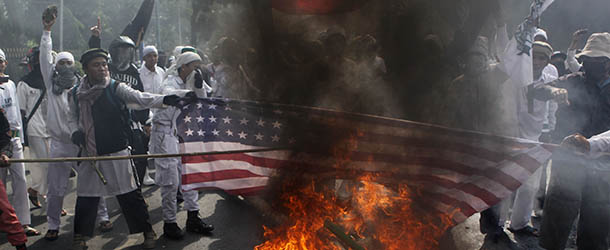 Muslim protesters burn a U.S. flag during a protest against American-made film &#8220;Innocence of Muslims&#8221; that ridicules Islam and depicts the Prophet Muhammad as a fraud, a womanizer and a madman, outside the U.S. Embassy in Jakarta, Indonesia, Monday, Sept. 17, 2012. (AP Photo/Dita Alangkara)
