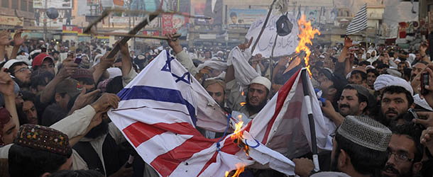 Pakistani Muslim demonstrators burn a US and Israeli flag during a protest against an anti-Islam film in Quetta on September 20, 2012. Up to 50 people were injured on September 20 as police clashed with thousands of protesters, some carrying the banners of extremist groups, demonstrating in Islamabad against an anti-Islam film. AFP PHOTO / BANARAS KHAN (Photo credit should read BANARAS KHAN/AFP/GettyImages)
