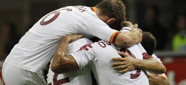 AS Roma midfielder Alessandro Florenzi, covered by his teammates, celebrates after scoring during the Serie A soccer match between Inter Milan and Roma at the San Siro stadium in Milan, Italy, Sunday, Sept. 2, 2012. (AP Photo/Antonio Calanni)
