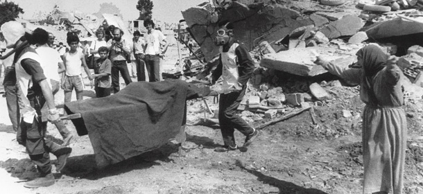 A Palestinian woman cries while civil defense workers carry the body of one of her relatives away from the rubble of her home in the Palestinian refugee camp of Sabra, in West Beirut 19 September 1982. Hundreds of Palestinians were killed in Sabra and Shatila, the two biggest camps in Lebanon. (Photo credit should read STF/AFP/Getty Images)