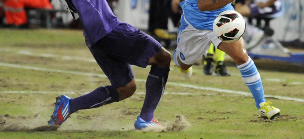 Napoli's Lorenzo Insigne challenges for the ball with Fiorentina defender Facundo Roncaglia, of Argentina, during a Serie A soccer match between Napoli and Fiorentina at San Paolo Stadium in Naples, Italy, Sunday, Sept. 2, 2012. (AP Photo/Salvatore Laporta)
