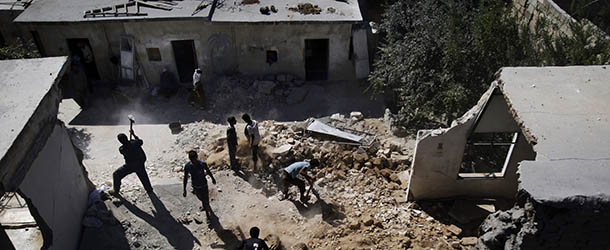 Syrians clear the rubble of a house which was destroyed in government airstrike on Saturday, in Kal Jubrin, on the outskirts of Aleppo, Syria, Sunday, Sept. 16, 2012. (AP Photo/Muhammed Muheisen)
