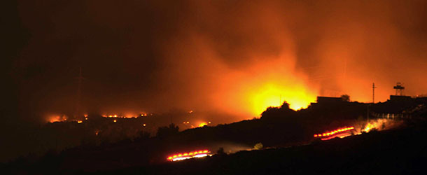 A glow of a large fire seen after an explosion at an ammunition store in Afyonkarahisar in western Turkey which has killed some 25 soldiers and wounded at least four others, Thursday, Sept. 6, 2012. The blast happened on Wednesday night at a military storage for hand grenades in Afyon, military said. Environment Minister Veysel Eroglu said the explosion was most likely caused by an accident and certainly not as a result of terrorism. It is thought many of the soldiers were trapped inside the building as firefighters tackled the huge blaze. (AP Photo) TURKEY OUT