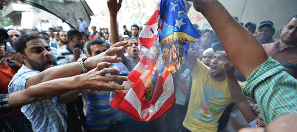 Egyptian protesters burn the US flag during a demonstration against a film deemed offensive to Islam on September 12, 2012 outside the US embassy in Cairo. Egyptian authorities called for restraint in the face of outrage over a film called "Innocence of Muslims" and considered offensive to Islam that has raised fears of renewed sectarian tensions. AFP PHOTO/ KHALED DESOUKI (Photo credit should read KHALED DESOUKI/AFP/GettyImages)