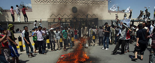 Yemeni protesters gather around fire during a demonstration outside the US embassy in Sanaa over a film mocking Islam on September 13, 2012. Yemeni forces managed to drive out angry protesters who stormed the embassy in the Yemeni capital with police firing warning shots to disperse thousands of people as they approached the main gate of the mission. AFP PHOTO/MOHAMMED HUWA (Photo credit should read MOHAMMED HUWAIS/AFP/GettyImages)
