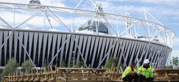 LONDON, ENGLAND &#8211; SEPTEMBER 13: Workmen take a break on a row of upturned benches outside the Olympic Stadium in Stratford on September 13, 2012 in London, England. The transformation of much of the site has already begun before being handed over to the &#8216;London Legacy Development Corporation&#8217; in October. As the sites redevelopment takes shape, the whole area including the athletes village and sports venues will be transformed into new neighborhoods, leisure centres and visitor attractions as part of Â£292 Million GBP scheme which is due to be completed by spring 2014. (Photo by Dan Kitwood/Getty Images)
