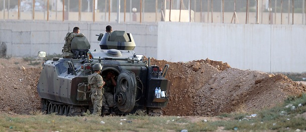A Turkish army armoured personnel carrier is dug in on the border with Syria near Akcakale on October 7, 2012. Syrian mortar fire again struck a Turkish border village on Sunday, prompting artillery retaliation for the fourth day. AFP PHOTO (Photo credit should read STR/AFP/GettyImages)
