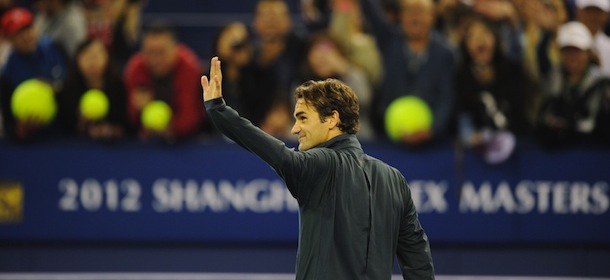 Roger Federer of Switzerland waves to his fans after beating Stanislas Wawrinka of Switzerland in their third round match of the Shanghai Masters tennis tournament in Shanghai, on October 11, 2012. Federer won 4-6, 7-6, 6-0. AFP PHOTO/Peter PARKS (Photo credit should read PETER PARKS/AFP/GettyImages)
