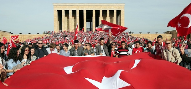 Thousands of people holding national flags gather at the mausoleum of Ataturk to celebrate the country&#8217;s Republic Day in Ankara, on October 29, 2012. Thousands of pro-secular Turks marched in Ankara to mark Republic Day, defying a ban by the moderate Islamist government. Carrying national flags, demonstrators shouted slogans, &#8220;Fully independent Turkey,&#8221; and &#8220;We are soldiers of Mustafa Kemal,&#8221; referring to the republic&#8217;s founding father. AFP PHOTO / ADEM ALTAN (Photo credit should read ADEM ALTAN/AFP/Getty Images)
