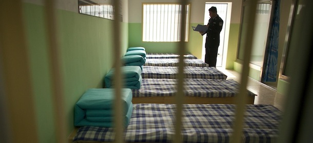 A police officer prepares his speech to journalists taking part in a government-organized tour inside an empty cell at the Number One Detention Center in Beijing Thursday, Oct. 25, 2012. Detention centers in China are primarily for people who have been detained by police on suspicion of committing a criminal offense and are awaiting trial. (AP Photo/Alexander F. Yuan)
