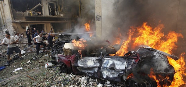 Lebanese firefighters extinguish burning cars at the scene of an explosion in the mostly Christian neighborhood of Achrafiyeh, Beirut, Lebanon, Friday Oct. 19, 2012. Lebanon&#8217;s state-run news agency says a massive blast in east Beirut was caused by a car bomb and that there are casualties. An Associated Press reporter at the scene saw bloodied people being helped into ambulances and heavy damage to what appeared to be residential buildings. (AP Photo/Hussein Malla)
