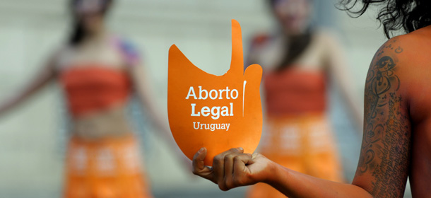 Pro abortion activists demonstrate in front of the Uruguayan congress in Montevideo, Uruguay, Tuesday, Sept. 25, 2012. Uruguay&#8217;s congress appeared ready on Tuesday to legalize abortion, a groundbreaking move in Latin America, where no country save Cuba has made abortions accessible to all women during the first trimester of pregnancy. The sign reads in Spanish &#8220;legal abortion.&#8221; (AP Photo/Matilde Campodonico)

