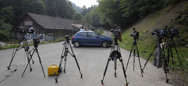 LaPresse
06-09-2012 Chevaline, Francia
estero
Alta Savoia, uccisa famiglia britannica in vacanza sul lago
Cameras are seen in front of Gendarmes who blocks access to a site where people were shot to death near Chevaline, French Alps, Thursday Sept. 6, 2012. A 4-year-old British girl hid for eight hours beneath the bodies of slain family members in the back of their car before she was discovered by French investigators who had been guarding the vehicle, a prosecutor said Thursday. Three people â a man and two women â had been shot to death, as was a French cyclist whose body was found nearby.
