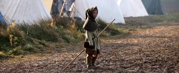 BATTLE, ENGLAND &#8211; OCTOBER 14: A child member of an historical re-enactment group dressed as a Norman soldier stands in his encampment before the annual re-enactment of the Battle of Hastings at Battle Abbey on October 14, 2012 in Battle, England. One thousand and sixty six Saxon and Norman soldiers from re-enactment groups across Europe will aim to faithfully recreate the Battle of Hastings in 1066 which saw the death of King Harold. (Photo by Oli Scarff/Getty Images)
