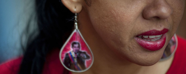 A woman wears an earring with the image of Venezuela&#8217;s President Hugo Chavez during his closing campaign rally in downtown Caracas, Venezuela, Thursday, Oct. 4, 2012. Chavez is running for re-election against opposition candidate Henrique Capriles on Oct. 7.(AP Photo/Sharon Steinmann)
