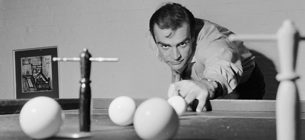 31st August 1962: Scottish actor Sean Connery, the new face of superspy James Bond, enjoys a game of bar billiards at his basement flat in London&#8217;s NW8. (Photo by Chris Ware/Keystone Features/Getty Images)
