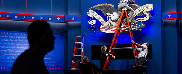 Workers put finishing touches on the stage a day ahead of the final presidential debate to be held at the Wold Performing Arts Center at Lynn University in Boca Raton, Florida, on October 21, 2012. US President Barack Obama and Republican Presidential candidate Mitt Romney are spending the weekend hammering out their foreign policy battle lines ahead of their final debate, dropping off the campaign trail and dispatching their running mates to court voters in battleground states. AFP PHOTO / Saul LOEB (Photo credit should read SAUL LOEB/AFP/Getty Images)
