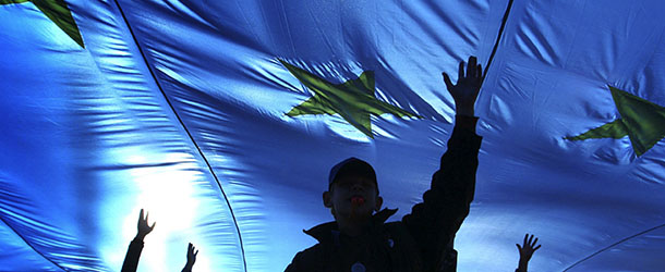 Young supporters of Belarus&#8217;s opposition carry a European Union flag as they walk along a street during the &#8220;European march&#8221; rally in Minsk, 14 October 2007. Thousands of demonstrators took to the streets of Minsk amid a heavy police presence to call for greater political freedom and for Belarus to join the European Union. AFP PHOTO VIKTOR DRACHEV (Photo credit should read VIKTOR DRACHEV/AFP/GettyImages)
