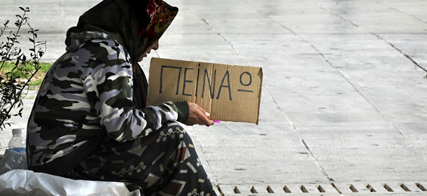 A woman holds a cardboard reading in Greek &#8220;I&#8217; m hungry&#8221; on March 17, 2011 in central Athens. The ravaged Greek economy will likely hit a nadir in the second half of this year and then start regaining strength, the International Monetary Fund (IMF) said on March 16 in a report on its bailout program. AFP PHOTO/ LOUISA GOULIAMAKI (Photo credit should read LOUISA GOULIAMAKI/AFP/Getty Images)
