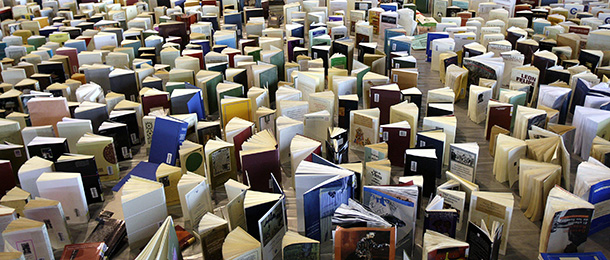 Thousands of books, which have been damaged by fire water after a burning at the faculty of Arts at the Geneva university on June 29, stand at the Palexpo hall in Geneva, Thursday, July 3, 2008, in order to be dried. (AP Photo/KEYSTONE/Martial Trezzini)
