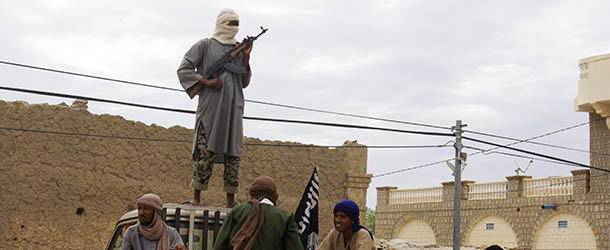 FILE In this Friday, Aug. 31, 2012 file photo, fighters from Islamist group Ansar Dine stand guard as they prepare to publicly lash a member of the Islamic Police found guilty of adultery, in Timbuktu, Mali. Ordinary Malians and international experts alike are not sure what will reunite and bring back political stability to a country that until recently had a reputation as one of West Africa&#8217;s most steady democracies. Representatives of the United Nations, the African Union and regional body ECOWAS are to consider the situation on Oct. 19, 2012 in a meeting in Mali&#8217;s capital, Bamako. (AP Photo, File)
