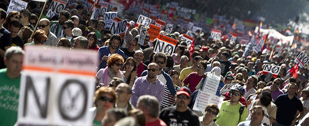 People hold banners against cuts during a demonstration in Madrid, Spain, Sunday, Oct. 7, 2012. Thousands of people called by 150 organizations are marching in 56 Spanish cities to protest punishing austerity cuts they say will only increase unemployment and job insecurity. (AP Photo/Alberto Di Lolli)
