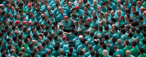 TARRAGONA, SPAIN &#8211; OCTOBER 07: Members of the Colla &#8216;Castellers de Vilafranca&#8217; start a construction of a human tower during the 24th Tarragona Castells Comptetion on October 7, 2012 in Tarragona, Spain. The &#8216;Castellers&#8217; who build the human towers with precise techniques compete in groups, known as &#8216;colles&#8217;, at local festivals with aim to build the highest and most complex human tower. The Catalan tradition is believed to have originated from human towers built at the end of the 18th century by dance groups and is part of the Catalan culture. (Photo by David Ramos/Getty Images)
