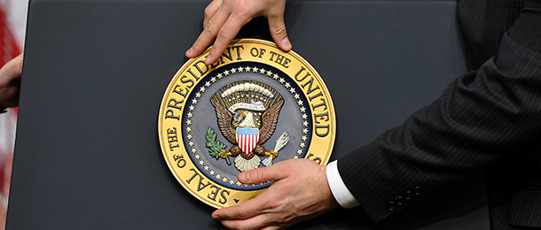 A staff fixes the presidential seal before US President Barack Obama gives a press conference in the Eisenhower Executive Office Building at the White House in Washington, DC, on December 22, 2010. Obama celebrated the Senate ratification of a nuclear arms reduction treaty with Russia, saying it &#8220;sends a powerful signal to the world.&#8221; AFP PHOTO/Jewel Samad (Photo credit should read JEWEL SAMAD/AFP/Getty Images)
