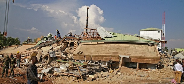 Workers search the debris of a collapsed building in Accra, Ghana, Wednesday, Nov. 7, 2012. A five-story shopping center built earlier this year in a bustling suburb of Ghana&#8217;s capital collapsed Wednesday, killing at least one person and leaving several dozen people trapped in the rubble, authorities and eyewitnesses said. (AP Photo/ Christian Thompson)
