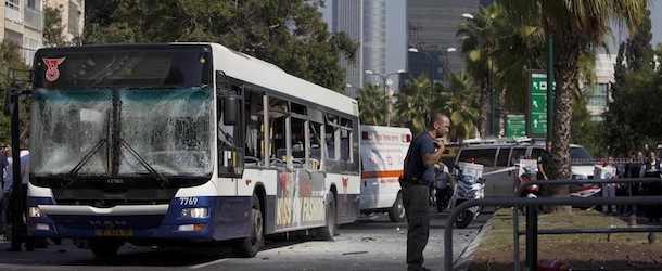 An Israeli security officer stands next to a blown up bus at the site of a bombing in Tel Aviv, Israel, Wednesday, Nov. 21, 2012. A bomb ripped through an Israeli bus near the nation&#8217;s military headquarters in Tel Aviv on Wednesday, wounding several people, Israeli officials said. The blast came amid a weeklong Israeli offensive against Palestinian militants in Gaza. (AP Photo/Oded Balilty)
