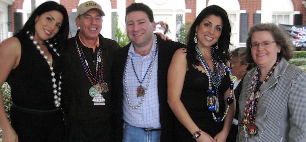 In this Jan. 30, 2010 photo, Natalie Khawam, left, Gen. David Petraeus, Scott and Jill Kelley, and Holly Petraeus watch the Gasparilla parade from the comfort of a tent on the Kelley&#8217;s front lawn in Tampa, Fla. Jill Kelley is identified as the woman who received threatening emails from Gen. David Petraeus&#8217; paramour, Paula Broadwell. Jill Kelley serves as the State Department&#8217;s liaison to the military&#8217;s Joint Special Operations Command. (AP Photo/The Tampa Bay Times, Amu Scherzer) TAMPA OUT; CITRUS COUNTY OUT; PORT CHARLOTTE OUT; BROOKSVILLE HERNANDO TODAY OUT; USA TODAY OUT; TV OUT; NO WEB USE; MAGS OUT
