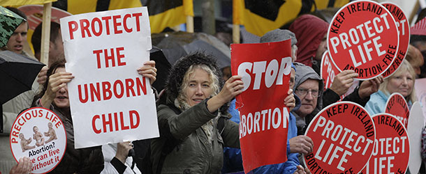 Protesters opposed to abortion hold placards outside the Marie Stopes clinic in Belfast, Northern Ireland, Thursday, 18, 2012. The first abortion clinic on the island of Ireland has opened in Belfast, sparking protests by Christian conservatives from both the Catholic and Protestant sides of Northern Irelandâs divide. The Marie Stopes center plans to offer the abortion pill to women less than nine weeks pregnant _ but only if doctors determine theyâre at risk of death or long-term health damage from their pregnancy. Thatâs the law in both Northern Ireland and the Republic of Ireland, where abortion is otherwise illegal. (AP Photo/Peter Morrison)
