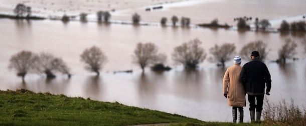 GLASTONBURY, UNITED KINGDOM &#8211; NOVEMBER 25: People walk from Glastonbury Tor as flood water in the fields below is seen, on November 25, 2012 in Somerset, England. Another band of heavy rain and wind continued to bring disruption to many parts of the country today particularly in the south west which was already suffering from flooding earlier in the week. (Photo by Matt Cardy/Getty Images)
