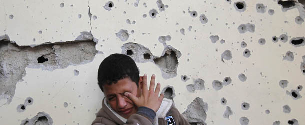 Palestinian boy Fares Sadallah, 11, cries as he sits outside his home which was damaged following an Israeli air strike in Beit Lahia, northern Gaza Strip, on November 16, 2012. Egypt&#8217;s premier vowed to intensify Cairo&#8217;s efforts to secure a truce and urged world leaders to end Israel&#8217;s &#8220;aggression&#8221; in Gaza, as he visited the Hamas-run enclave. AFP PHOTO/MOHAMMED ABED (Photo credit should read MOHAMMED ABED/AFP/Getty Images)
