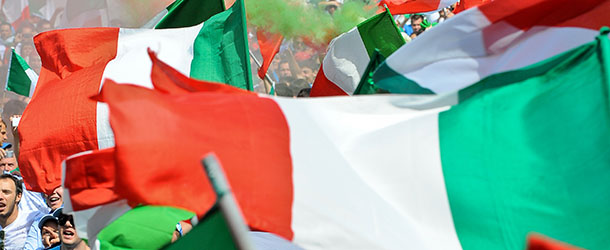 Italian fans wave the national flag as they watch the football game between Italy and Slovakia on a giant screen at Villa Borghese in Rome on June 24, 2010 as part of the 2010 FIFA World Cup held in South Africa. Italy was defeated 3-2. AFP PHOTO / ANDREAS SOLARO (Photo credit should read ANDREAS SOLARO/AFP/Getty Images)
