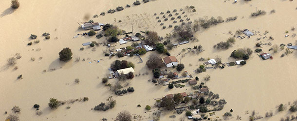 An aerial view of the area around the town of Orte, near Rome, where various homes, activities and infrastructures were damaged by flood water Tuesday, Nov. 13, 2012, as heavy rains battered north, central Italy and hard-hit Tuscany. Three people died after their car fell off a bridge that collapsed due to severe rainfalls, Tuesday near the town of Grosseto, Tuscany. (AP Photo/Giuseppe Palozzi)
