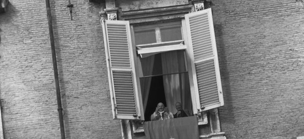 Pope John XXIII, with Cardinal Amleto Giovanni Cicognani, Vatican Secretary of State, at his side greets a crowd estimated at 10,000 gathered in Saint Peter&#8217;s Square, from the window if his private apartment in the Vatican palace, Oct. 29, 1961. The crowd cheered the Pope for the third anniversary of his election to the pontificate on October 28, and for his forthcoming birthday. (AP Photo/Jim Pringle)
