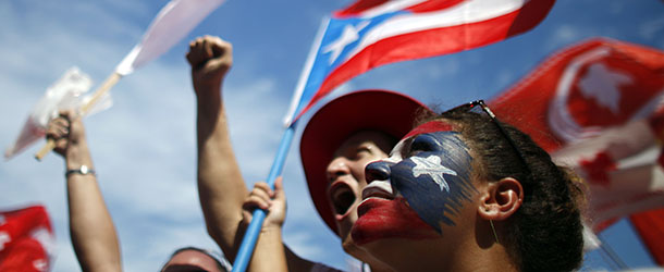 Supporters of Alejandro Garcia Padilla, candidate for governor of the pro-commonwealth Popular Democratic Party, cheer during his closing campaign rally in San Juan, Puerto Rico, Sunday, Nov. 4, 2012. Puerto Rican voters will once again ponder the decades-old question over the island&#8217;s political future when they go to the polls Tuesday: What kind of relationship do they really want with the United States? Officially, the Caribbean island is the U.S. Commonwealth of Puerto Rico, a semi-autonomous extension of the U.S. mainland, its giant neighbor 1,000 miles to the northwest. (AP Photo/Ricardo Arduengo)
