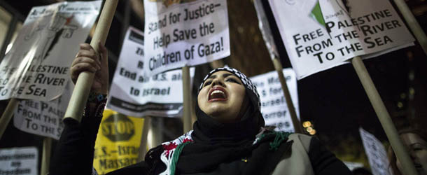 Rabab Idly, 18, of Brooklyn, chants during an anti-war protest regarding the expanding hostilities between Israel and Hamas in the Gaza Strip on 42nd Street, Monday, Nov. 19, 2012, in New York. Israel and Gaza&#8217;s Hamas rulers traded fire and tough cease-fire proposals Monday, and threatened to escalate their border conflict if diplomacy fails. No deal appeared near. (AP Photo/John Minchillo)
