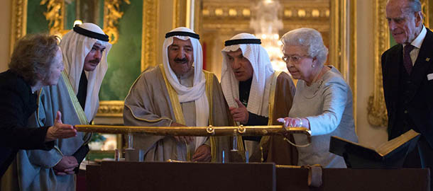 WINDSOR, ENGLAND &#8211; NOVEMBER 27: The Amir Sheikh Sabah Al-Ahmad Al-Jaber Al-Sabah of Kuwait (3rd L) Queen Elizabeth II and Prince Philip, Duke of Edinburgh (R) look at a gold sword that was presented to the Queen by Kuwait for her coronation in 1953 in the Green room at Windsor Castle during a three-day state visit on November 27, 2012 in Windsor, England. In the afternoon a military parade will be inspected at Royal Military Academy Sandhurst then a banquet is to be held at Windsor Castle in the Amir&#8217;s honour this evening. (Photo by Alastair Grant &#8211; WPA Pool/Getty Images)
